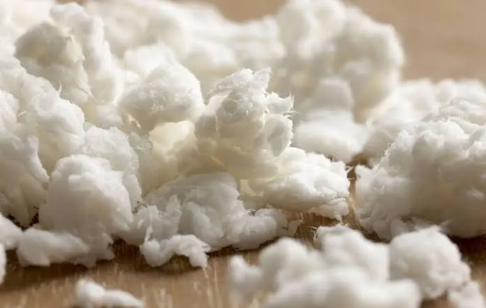 Close-up of white fluff pulp fibers used in the absorbent core of baby diapers, made from natural wood cellulose.